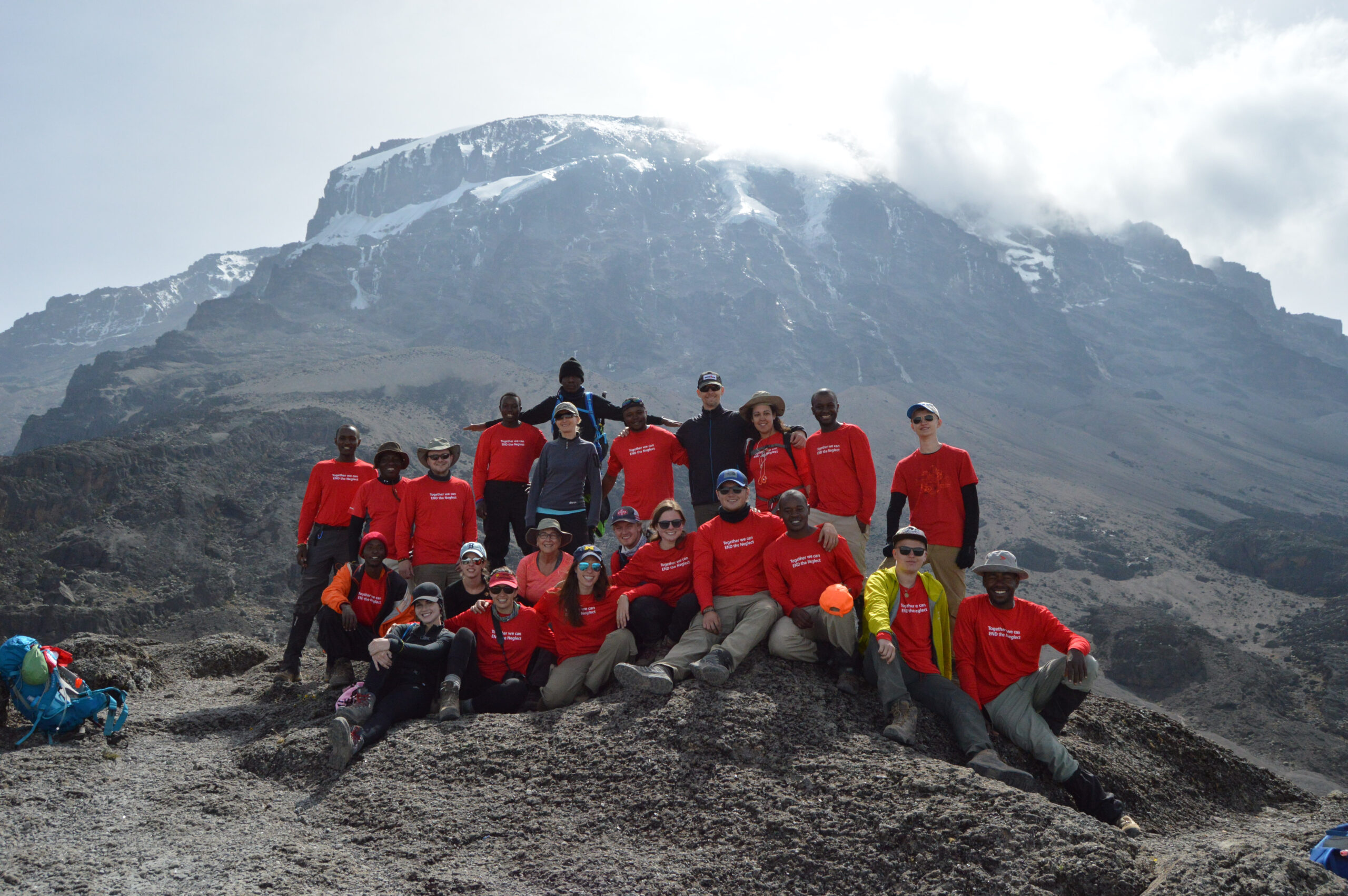 Climbers pose in front of Kilimanjaro.